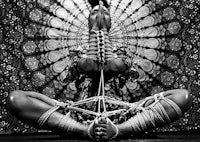 a black and white photo of a woman in a yoga pose